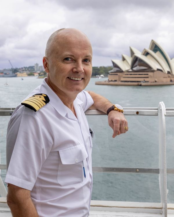 Azamara Ship Captain stands in front of the Sydney Opera House