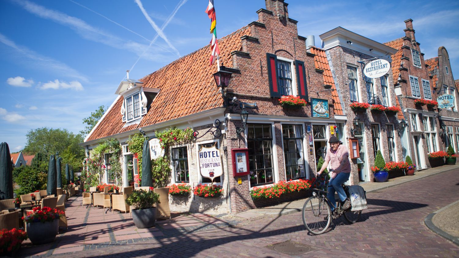 man biking through village