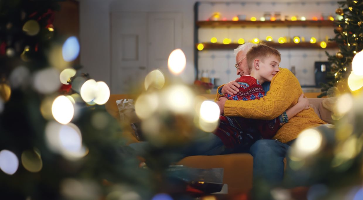 child and grandparent hug at holidays