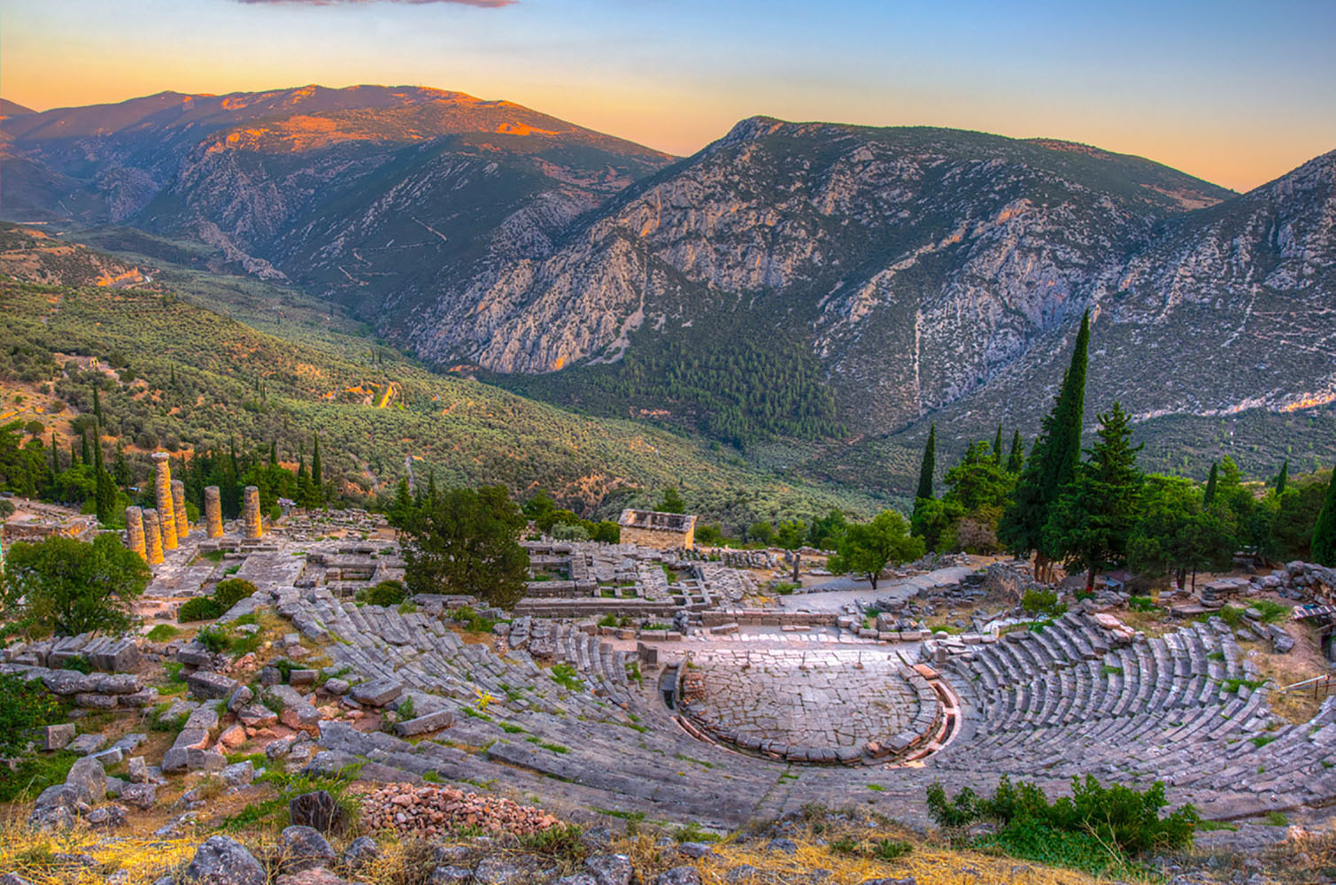 The ruins of a theatre in ancient Delphi, Greece at sunset