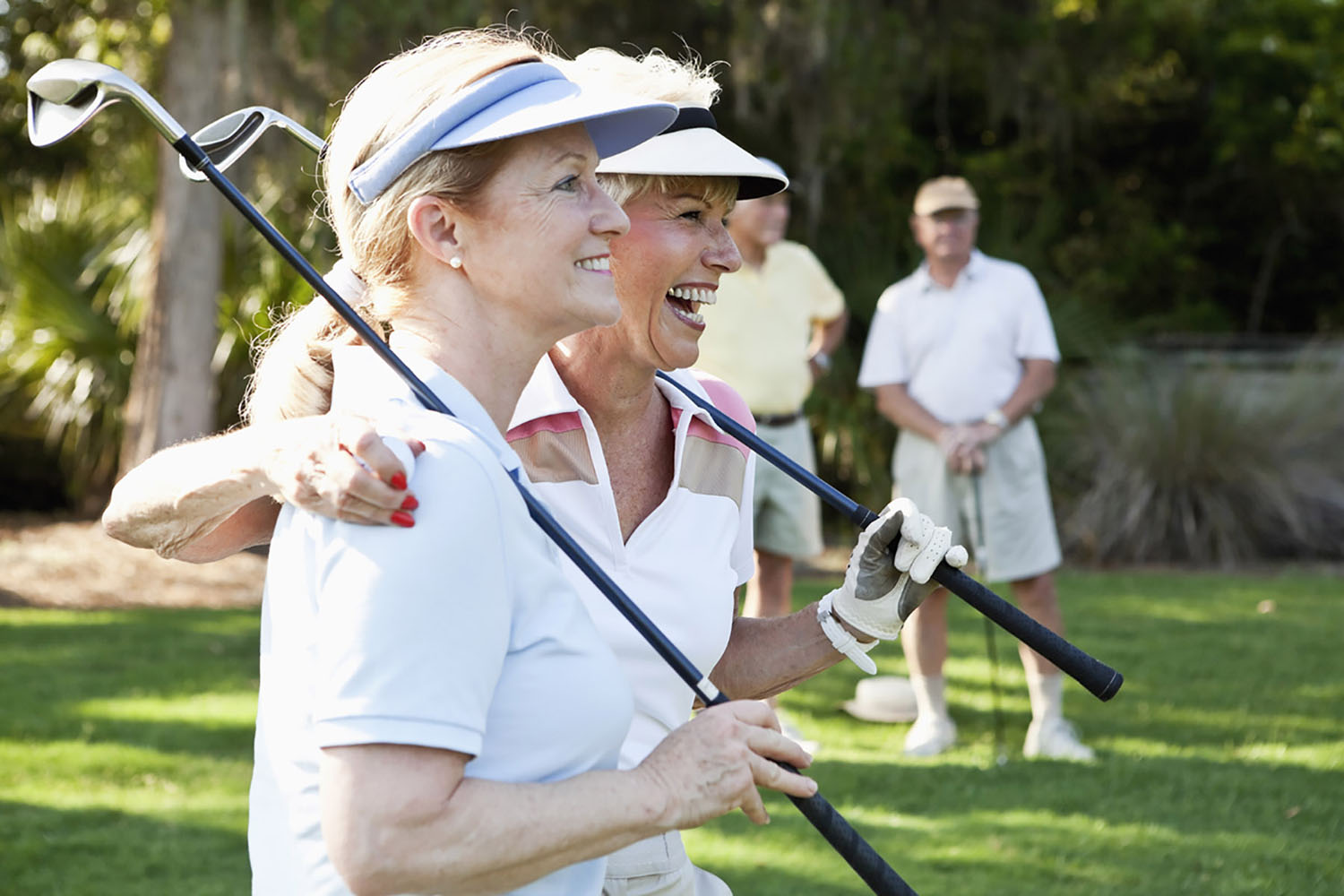 Senior couples playing golf.